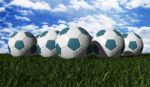 Cyan Soccer Balls On A Green Grass Stock Photo