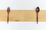 Red Wood Fork And Spoon On Wood Plate Stock Photo