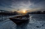 Sunrise At Seashore With Boat In Front Stock Photo