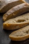 Sliced Ciabatta On The Dark Table Stock Photo