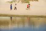 Young Brothers/sisters Walking On Beach Stock Photo