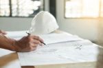 Person's Engineer Hand Drawing Plan On Blue Print With Architect Stock Photo