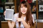 Portrait Of Thai Adult Student University Uniform Beautiful Girl Using Her Tablet Stock Photo