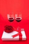 St Valentine's Setting With Present And Red Wine Stock Photo