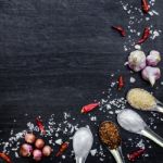 Top View Of Food Ingredients And Condiment On The Table, Ingredients And Seasoning On Dark Wooden Floor Stock Photo