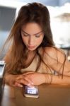 Brunette In Kitchen With Mobile Phone Stock Photo