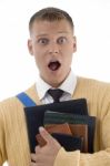 Shocked Male Student Holding Books Stock Photo