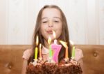 Little Girl Blowing Out The Candles Stock Photo