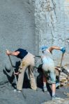 Worker Shovelling Concrete Stock Photo