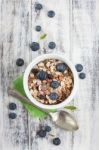 Bowl Of Muesli With Fresh Blueberries On White Wooden Table Stock Photo