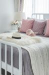 Pink Pillows With Pink Doll On White Wooden Bed And Classic Hat Stock Photo