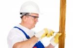 Worker Screwing Nail In Board Stock Photo