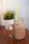 Iced Coffee With Green Plant Background Stock Photo