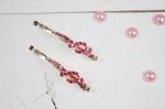 Golden Hairpins With Pink Gemstone And Pink Pearls On White Wood Stock Photo