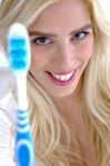 Front View Of Smiling Woman Holding Toothbrush Stock Photo