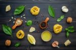 The Ingredients For Green Pesto Sauce On Dark Wooden Background Stock Photo