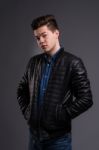 Casual Young Man In Black Leather Jacket And Denim Jeans Stock Photo