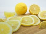 Fresh Lemon Slice On White Wood Background Stock Photo