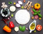 The Ingredients For Homemade Pizza On Dark Stone Background Stock Photo