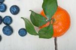 Tangerine And Blueberry On White Table Stock Photo