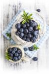 Blueberry Basket And Jug On White Wooden Table Stock Photo