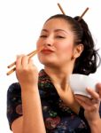 Girl Eating With Chop Sticks Stock Photo