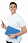 Smiling Man Holding Notebook Stock Photo