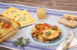 Fish With Potatoes And Tomato Stock Photo