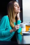 Pretty Young Woman Sitting In A Cafe With A Cup Of Coffee Stock Photo