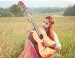 Hippie Girl Playing Guitar On Grass Stock Photo