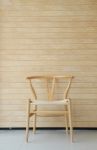 Wooden Chair With Wooden Wall In Background Stock Photo