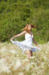 young Woman standing In Meadow Stock Photo