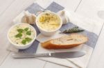 Baguette With Herb Butter And Rosemary Thyme On Rustic Wooden Background Stock Photo