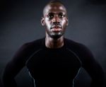 Athletic Man Running In Black Background Stock Photo