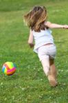 Happy Little Girl Playing Ball In The Park Stock Photo