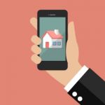 Hand Holding Smart Phone With House Icon Stock Photo