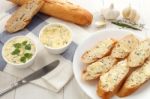 Baguette With Herb Butter And Rosemary Thyme On Rustic Wooden Background Stock Photo