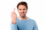 Angry Young Man Showing Middle Finger Stock Photo