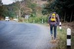 Tourists Man Walk Along Mountain Roads Stock Photo