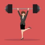 Business Woman Lifting A Heavy Weight Stock Photo