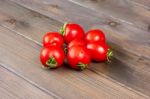 Fresh Tomatoes On The Dark Wooden Table Stock Photo