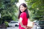 Portrait Of Thai Teen Beautiful Girl In Chinese Dress, Happy New Year And Open Box Gift, Smile And Very Happy Stock Photo