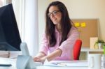 Beautiful Young Woman Working In Her Office Stock Photo