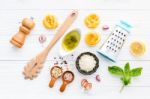 The Ingredients For Homemade Pesto Pasta On White Wooden Backgro Stock Photo