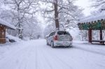 Car And Falling Snow In Winter On Forest Road With Much Snow Stock Photo