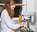 Dutch Teenage Girl Operating Electric Drilling Machine Stock Photo