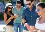 Portrait Of Group Of Friends Having Fun With Smartphones Stock Photo