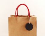 Brown Paper Bag With Black Tag Stock Photo