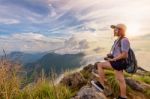 Girl Tourist On Mountains At Sunset Stock Photo