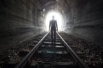 Man In A Tunnel Looking Towards The Light Stock Photo